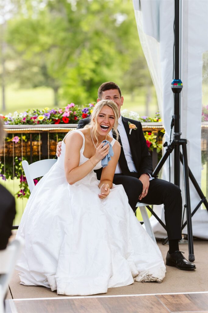 Bride and groom laugh and shed tears during speeches